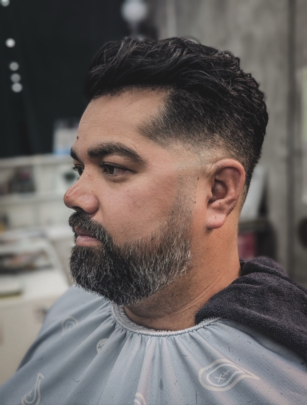 Low fade with a shaped beard